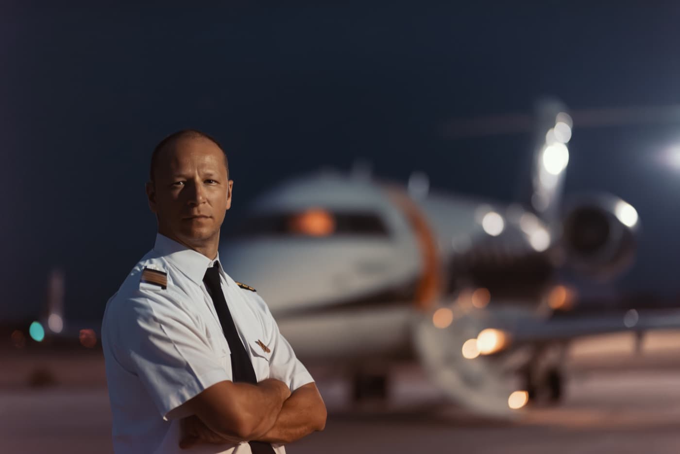Pilot in front of a private jet